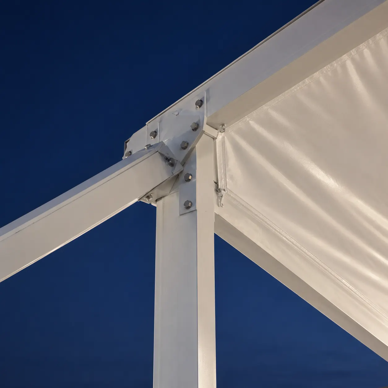 White aluminium clearspan tent truss joint with tensioned PVC roof fabric against a dusk sky — AI concept image